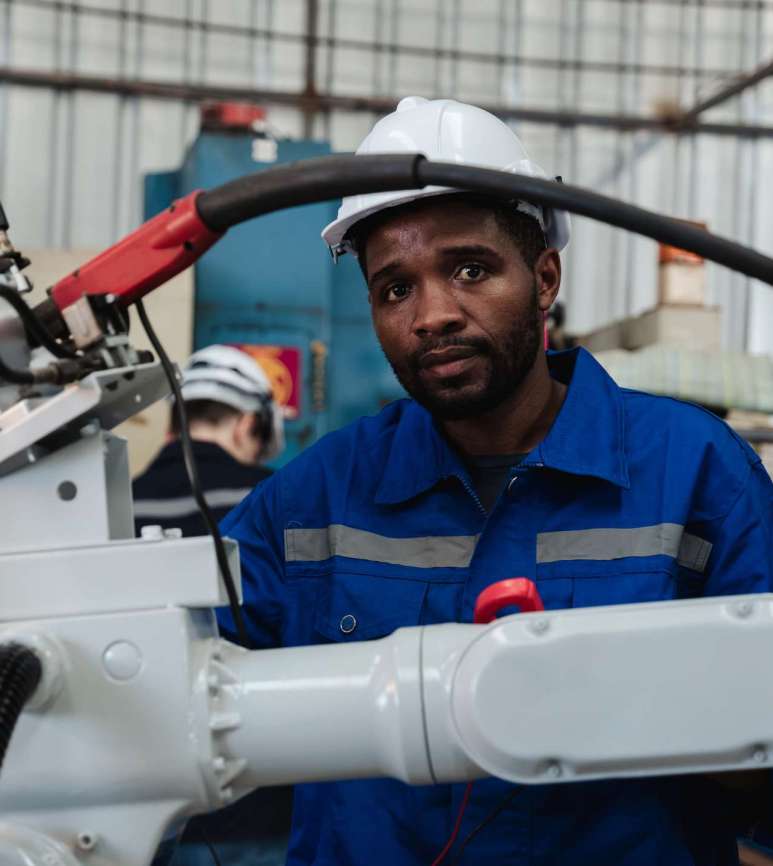 Industrial engineers are controlling the automated robot arms machine welding steel welding robots in industrial manufacturing factory.